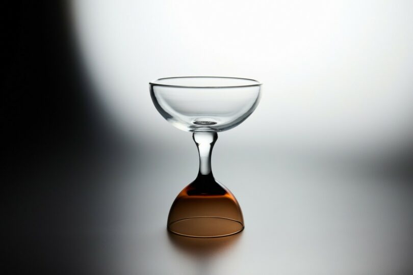 A clear glass with a brown base.
