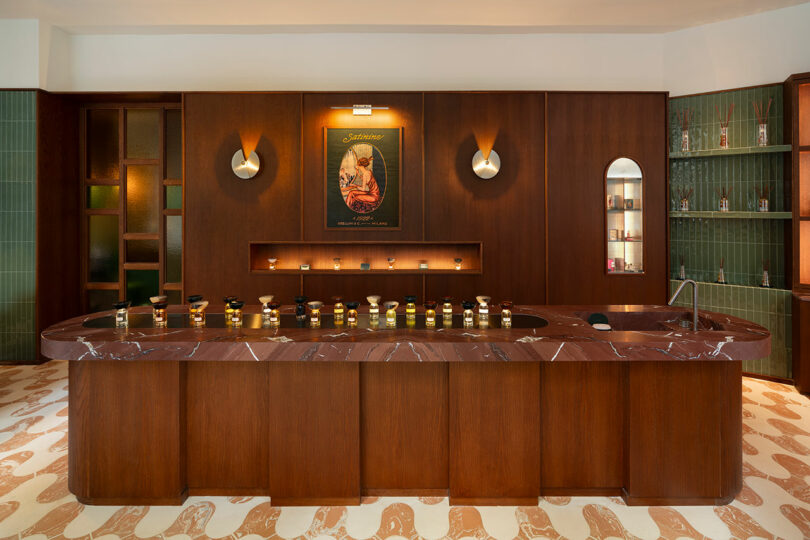 A modern perfume shop interior with a marble counter, various perfume bottles displayed, wood paneling, green tiled walls, and a vintage-style poster above shelves.
