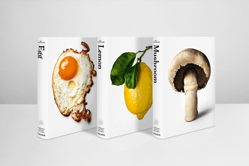 Three white books stand upright, each with a large photo on the cover—a fried egg, a lemon with leaves, and a mushroom—capturing the diverse taste of each ingredient. The titles are "Egg," "Lemon," and "Mushroom.