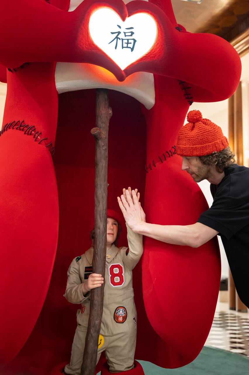Close-up of man giving doll a high-five