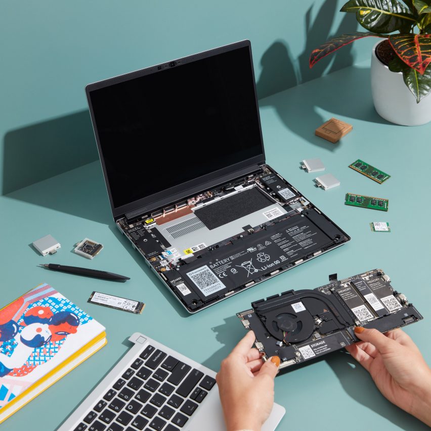 Hands putting together a modular Framework laptop