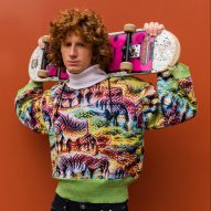 Person wearing Cap_able's garment and holding a skateboard