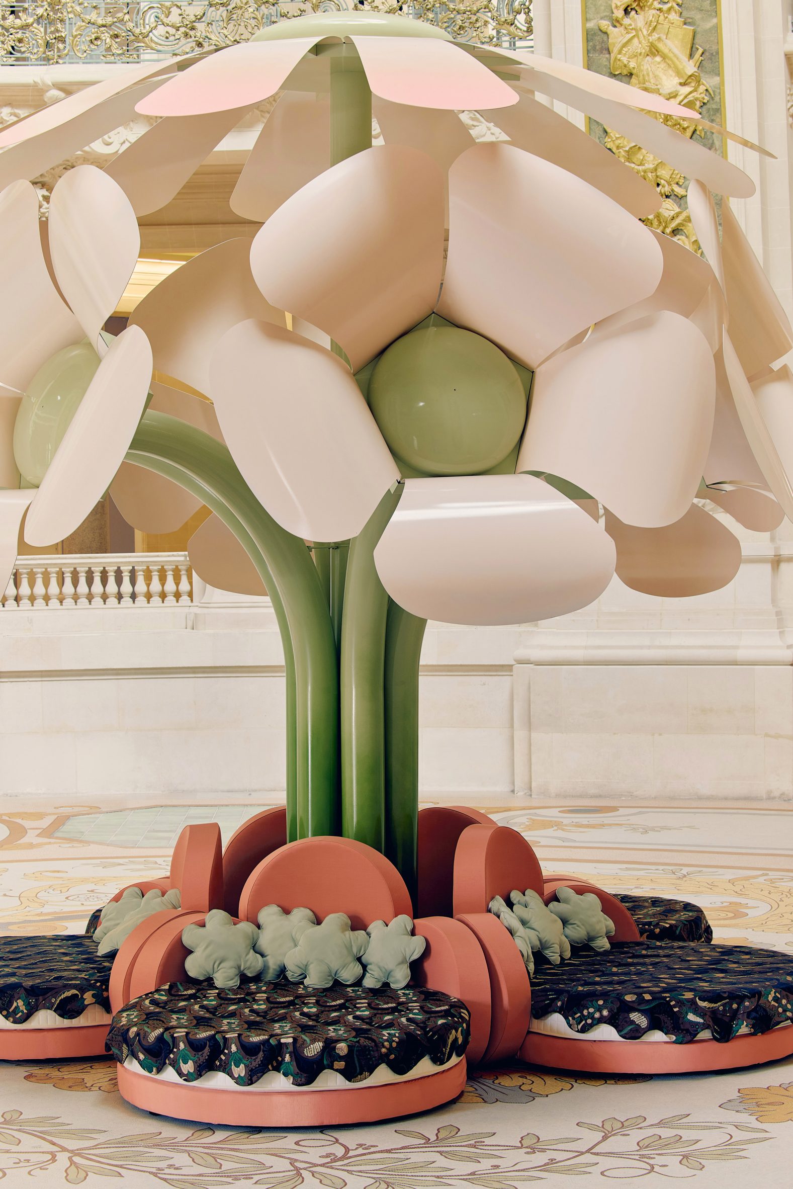 The installation features giant flowers made from metal