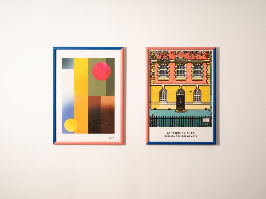 Photo of framed graphic prints on a white wall, one abstract, the other of a building facade