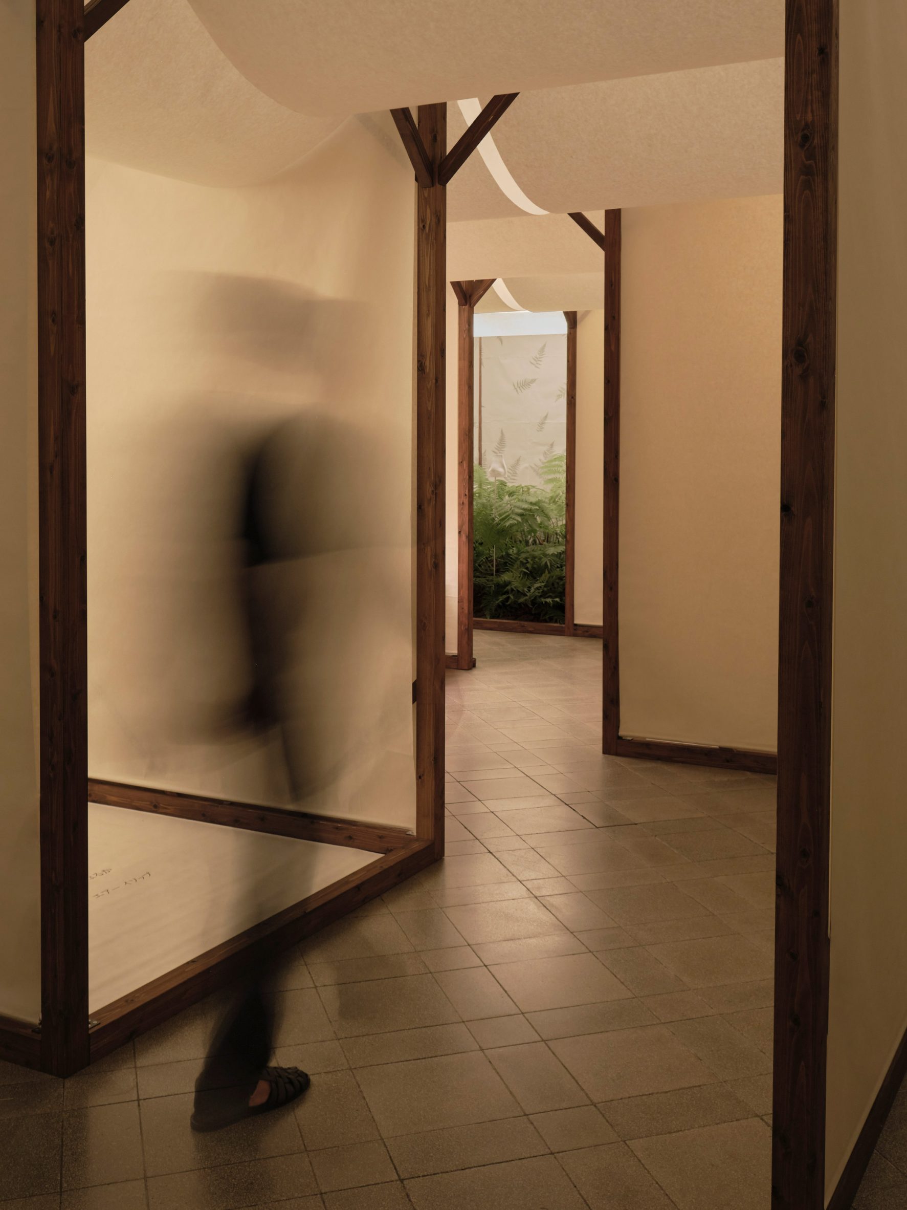Washi paper screens between timber frames in a softly lit installation