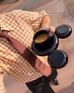 Man holding Mickey Mouse cup