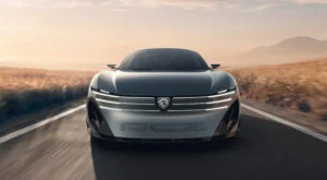 Front view of a silver Peugeot RCZ Vision concept car driving along a rural road